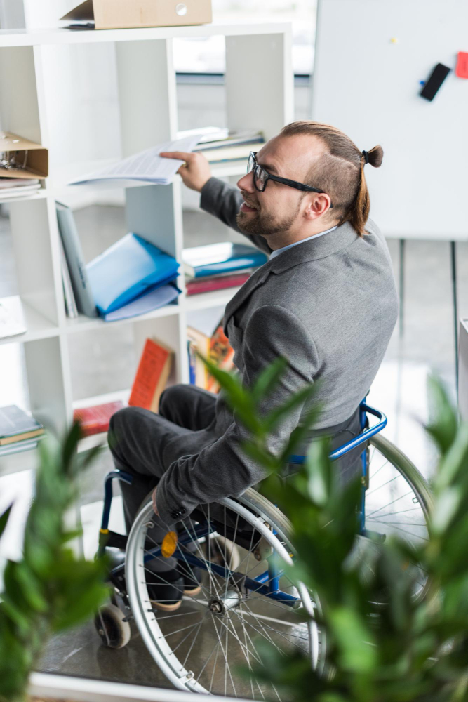 young-physically-handicapped-businessman-glasses-doing-paperwork-office